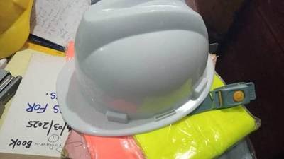 Grey safety helmet — site ppe held by LAMM Investment Company.