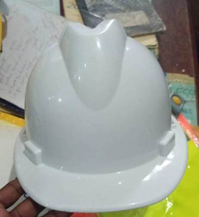 White safety helmet — site ppe held by LAMM Investment Company.